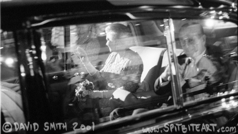 Queen Elizabeth II clearly viewed sitting in the back of the Royal Rolls Royce smiling and waving at the crowd after leaving the Royal Variety Performance in the Dominion Theatre on Tottenham Court Road in the centre of London on Monday November 26, 2001. Prince Philip is on the right of the picture but is a little blurred as the car was moving and I had used a slow shutter speed rather than flash.